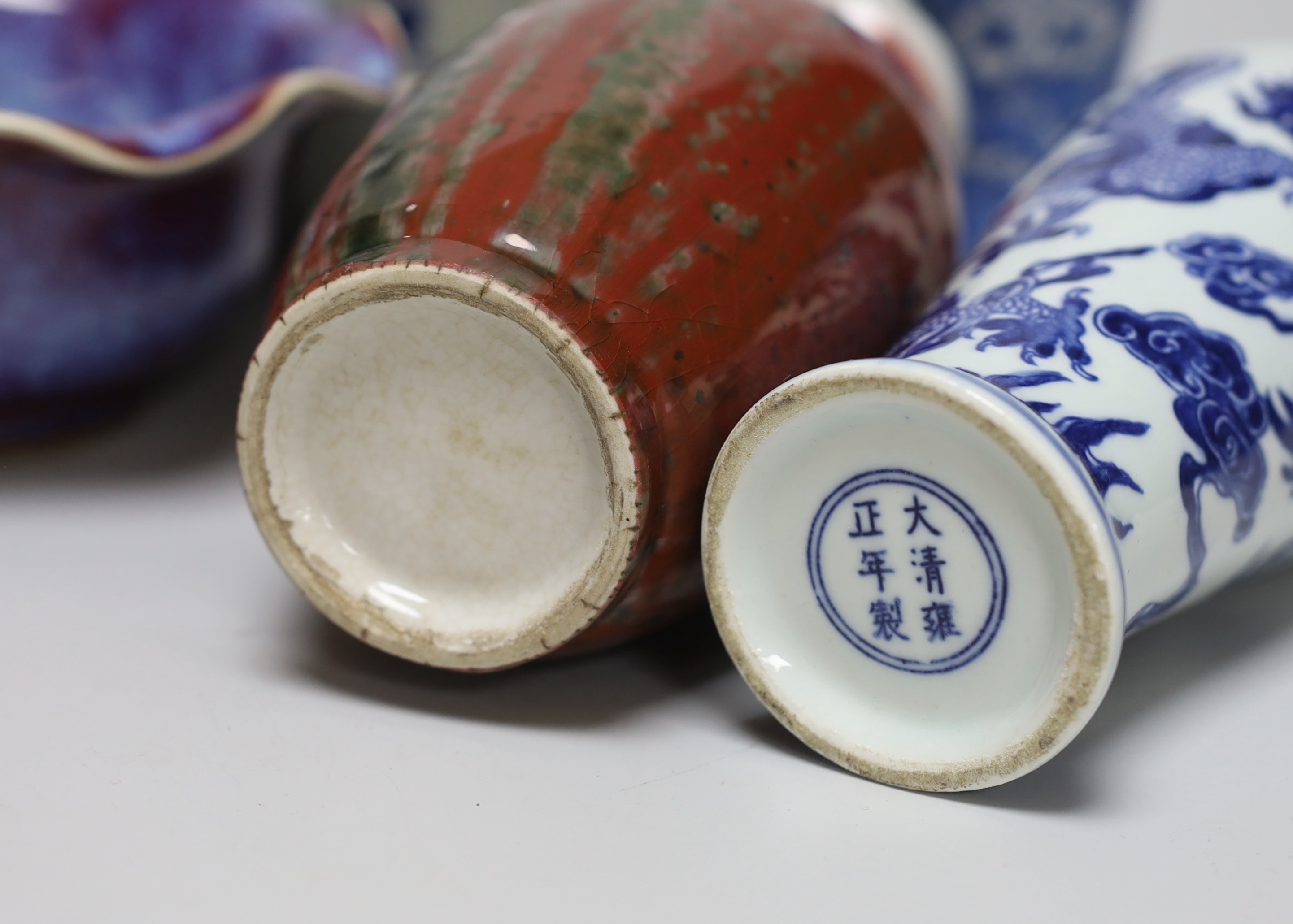 A group of Chinese blue and white ceramics including two prunus flower vases and three bowls and a Chinese flambe vase and a similar bowl